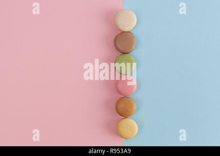 Row of  macarons on pink-blue background with copy space Stock Photo