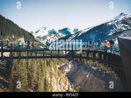 Tourists admiring the panorama while walking on the glass floor at Glacier Skywalk, Icefields Parkway, Alberta, Canada Stock Photo