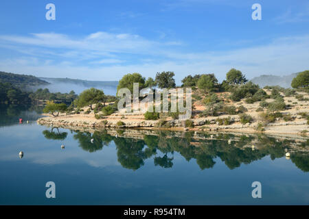 Mirror Image of Esparron Lake with Trees Reflected in Still Water , Esparron-de-Verdon, Alpes-de-Haute-Provence Provence France Stock Photo