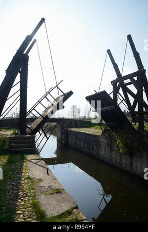 Silhouetted View of Langlois Bridge or Drawbridge aka Pont de Langlois or Van Gogh Bridge over a Canal at Arles Provence France Stock Photo