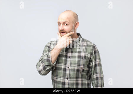 Middle aged man thinking, expressing leadership reflections and concerns, trying to make a decision. Stock Photo