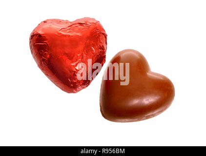 Red Foil wrapped chocolate hearts isolated on white background. Stock Photo