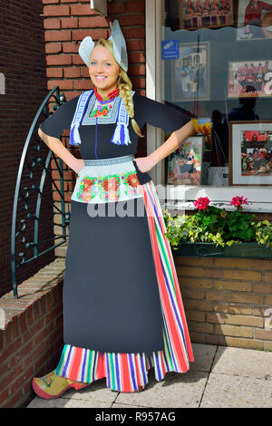 Cardboard cut out of Dutch girl in traditional costume in the tourist town of Volendam, North Holland, The Netherlands Stock Photo