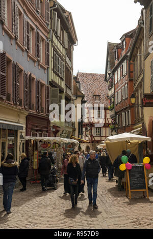 COLMAR, FRANCE - APRIL 2, 2018: Tourists walking through streets in old mediaval city of Colmar in France during Easter 2018 Stock Photo