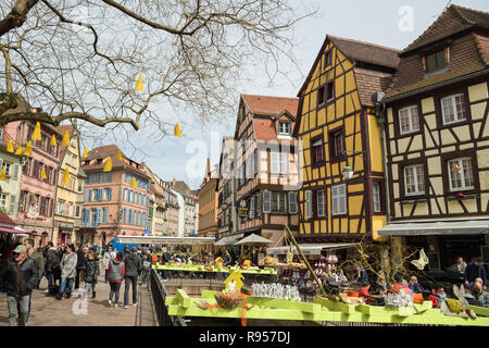 COLMAR, FRANCE - APRIL 2, 2018: Tourists enjoying walk through  decorated city of Colmar in France during Easter 2018 Stock Photo