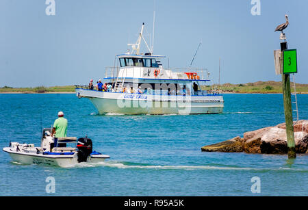 A fisherman watches as the Gulf Eagle, a deep sea fishing charter boat, returns to dock at Port Aransas Municipal Boat Harbor in Port Aransas, Texas. Stock Photo