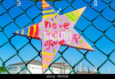 A “Never Give Up” sign hangs on a gratitude fence at the Texas Maritime Museum on the anniversary of Hurricane Harvey in Rockport, Texas. Stock Photo