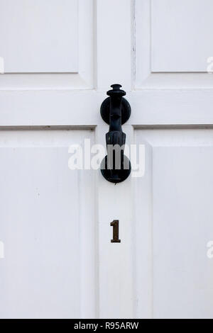 The house number 1 on a white painted door in Hertfordshire. Stock Photo