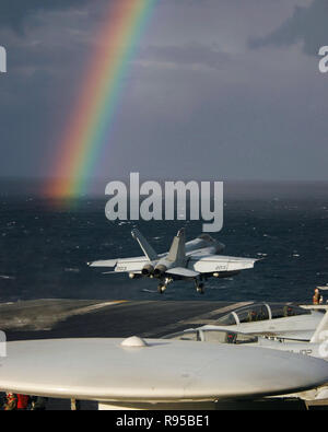 An F/A-18E Super Hornet, assigned to the 'Royal Maces' of Strike Fighter Squadron Two Seven (VFA-27), launches off the flight deck of the aircraft carrier USS Kitty Hawk (CV 63) during an early morning rain shower. U.S. Navy photo by Photographer's Mate Airman Stephen W. Rowe Stock Photo