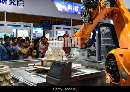 Industrial robot carving and engraving plaster pedestal at tech fair in Shenzhen, China Stock Photo