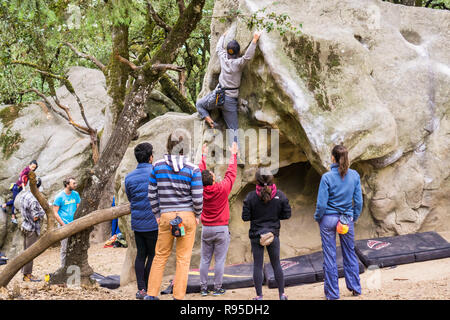 February 11, 2018 Los Gatos / CA / USA - Group of climbers practicing bouldering in the forests of Castle Rock State Park, Santa Cruz mountains, Calif Stock Photo