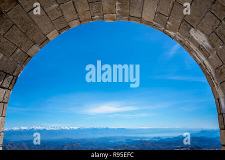 Stunning view of mountain winter landscape Lovcen National Park in Montenegro as seen from the tunnel leading to Njegos Mausoleum Stock Photo