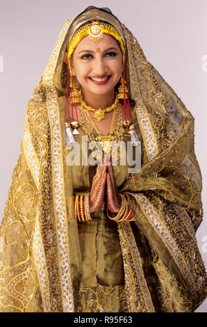 Kashmiri bride, folded hands, marriage dress, wedding dresses, India, MR Stock Photo