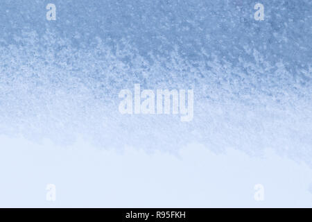 Full frame background of snow on light blue ice in the winter. Simple and minimal abstract background. Copy space. Stock Photo