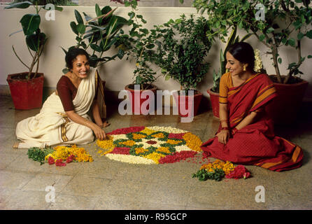Pookalam, Onam Festival, women making flower rangoli, Kerala, India, Asia Stock Photo