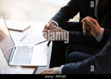 Close up businessmen in formal suits using computer working toge Stock Photo