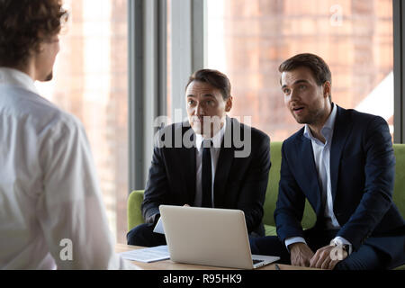 Surprised HR managers looking at job candidate Stock Photo