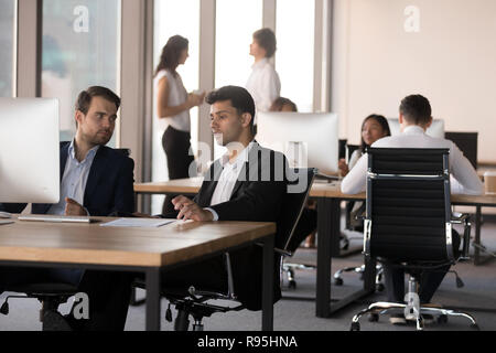 Middle eastern ethnicity and caucasian colleagues working togeth Stock Photo