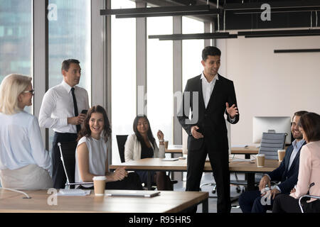 Middle eastern ethnicity team leader representing new project to Stock Photo