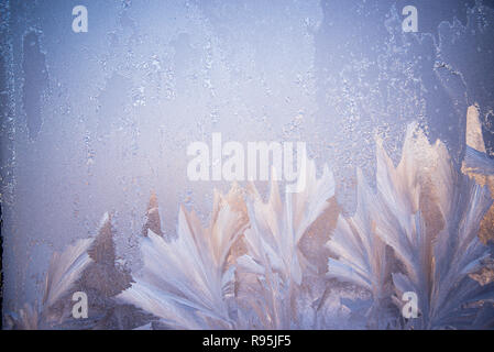Frosty pattern on the glass. Winter Christmas abstract backdrop. Frosted glass ice background, natural beautiful snowflakes. Stock Photo