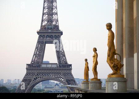 PARIS, FRANCE - JULY 7, 2018: Eiffel tower and golden staues, early morning in Paris, France Stock Photo