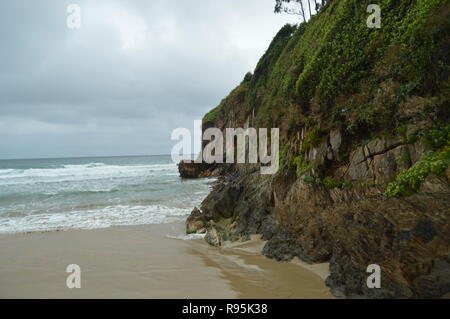Nice Green Cliff On The Beach Of El Aguilar On A Rainy Day. July 29, 2015. Landscapes, Nature, Travel. Muros De Nalon, Asturias, Spain. Stock Photo