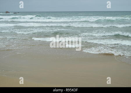 Waves Breaking With White Sand On The Beach Of El Aguilar On A Rainy Day. July 29, 2015. Landscapes, Nature, Travel. Muros De Nalon, Asturias, Spain. Stock Photo
