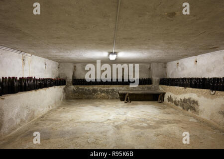 Basement with many wine bottles in old house interior Stock Photo