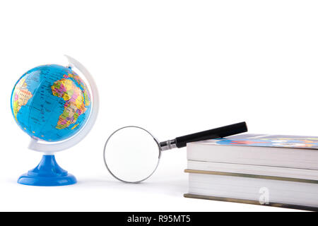Globe witn magnifying glass on book Stock Photo