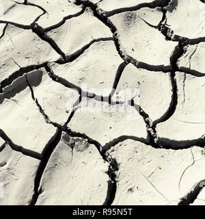 Close up of cracked, dried earth creating an abstract pattern. Stock Photo