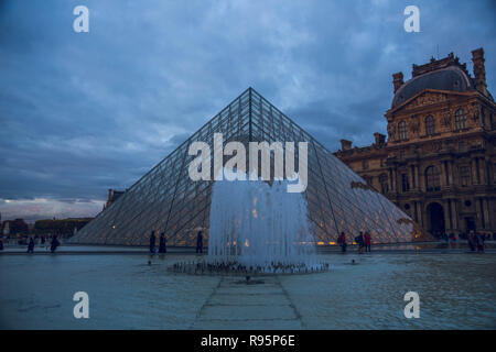 PARIS, FRANCE - OCTOBER 2018: The Louvre Museim Exterior duing the evening in Paris, France Stock Photo