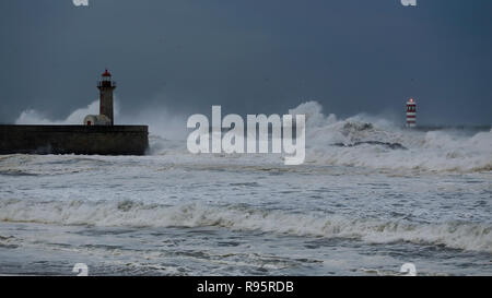 Dark seascape at dusk before rain and big storm. Douro river mouth south piers and beacons, North of Portugal. Stock Photo