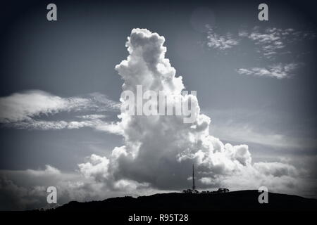 Towering cumulus cloud mimics the tv tower on Mt Kaukau, Wellington Stock Photo