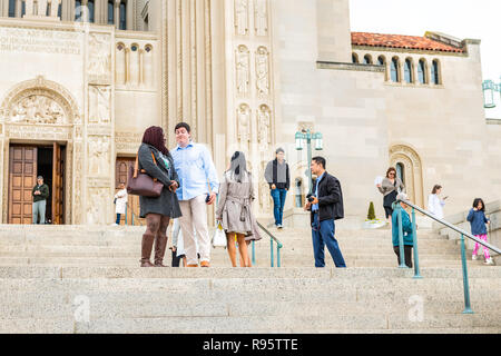 Washington DC, USA - April 1, 2018: People, couple standing in front of entrance of basilica of the National Shrine of the Immaculate Conception Catho Stock Photo