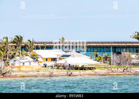 Many damaged, destroyed houses on beach by shore, coast in Florida keys, bridge after destruction of hurricane irma, houses after storm heavy wind Stock Photo