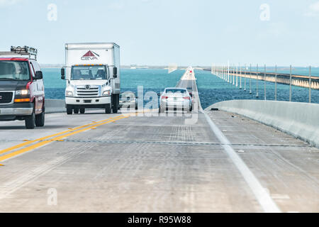Piegon Key, USA - May 1, 2018: Point of view driving, moving in car on seven mile bridge landscape of Florida Keys water, atlantic ocean, cars on Over Stock Photo