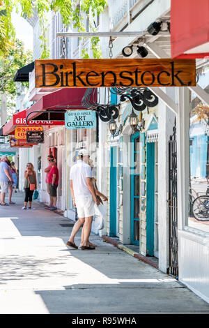 Key West, USA - May 1, 2018: Restaurants, cafe, Guild hall art gallery studio, stores, Birkenstock shoes shop, store on Duval street road, people, tou Stock Photo