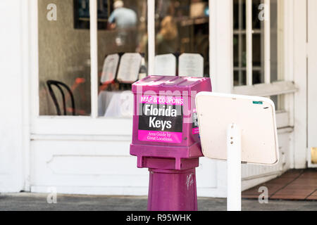 Key West, USA - May 1, 2018: Purple free newspaper, magazine stand, dispenser, box, area guide book, map, coupons in Florida keys urban city on Duval  Stock Photo