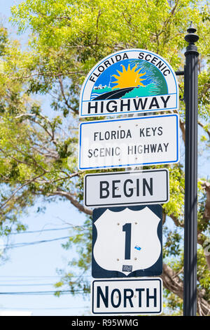 Key West, USA - May 1, 2018: Florida scenic highway, keys begin US1, US one, 1, North route, road street, overseas hwy, freeway sign with art painting Stock Photo