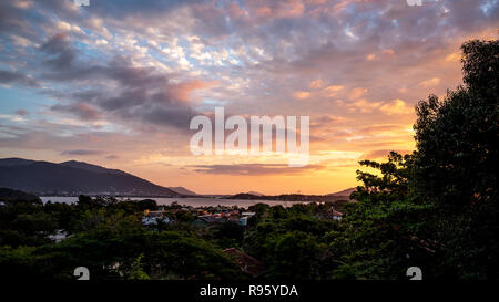 Stunning sunset at the Lagoon of the Concepcion.Clouds reflect the colorful tones on the blue sky. Florianópolis Island, Santa Catarina state, Brazil Stock Photo
