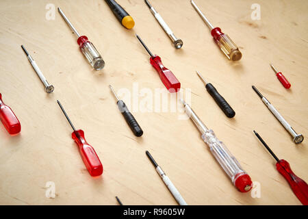 pattern background of various screwdrivers on  wooden work table Stock Photo