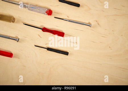 pattern background of various screwdrivers on  wooden work table Stock Photo