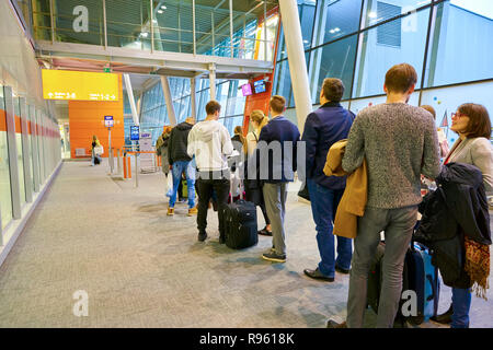 WARSAW, POLAND - CIRCA NOVEMBER, 2017: people waiting at the departure gate for boarding to flight in Warsaw Chopin Airport. Stock Photo