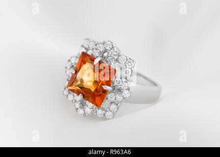 White Gold Ring With Citrine And Diamonds On Soft White Background Stock Photo