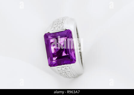 White Gold Ring With Amethyst And Diamonds On Soft White Background Stock Photo