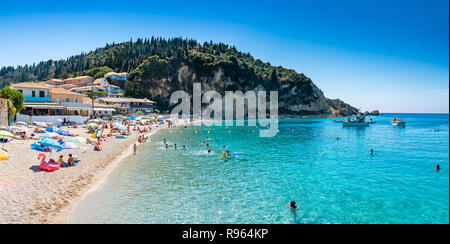 People in summer holiday on the seaside of Agios Nikitas beach, in Lefkada island of Greece - Europe Stock Photo