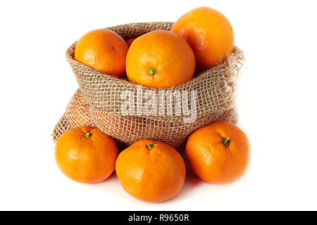 Mandarin orange (Citrus reticulata) also known as the mandarin or mandarine in burlap sack isolated on white background Stock Photo