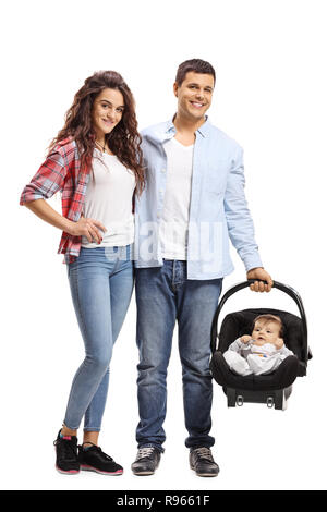 Full length portrait of a young family of a mother, father and a baby in an infant car seat isolated on white background Stock Photo