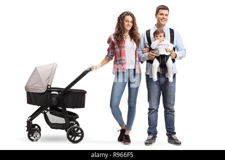 Full length portrait of a young mother with a stroller and a father with a baby in a carrier isolated on white background Stock Photo