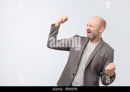 Portrait of a satisfied mature man celebrating success Stock Photo